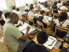 photo of a caligraphy lesson among Japanese pupils