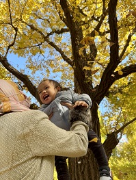 mother, child and autumn leaves